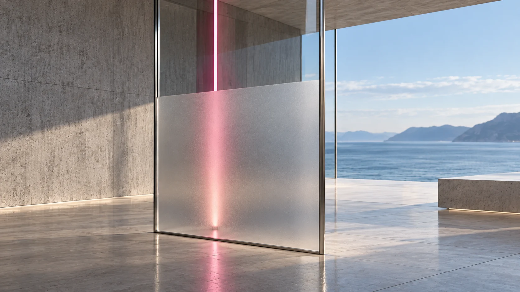 A sheet of glass standing on a terrace above the sea, clear above and frosted below: an upright line of rhodolite light is exact through the clear part and a soft glow through the frosted part.