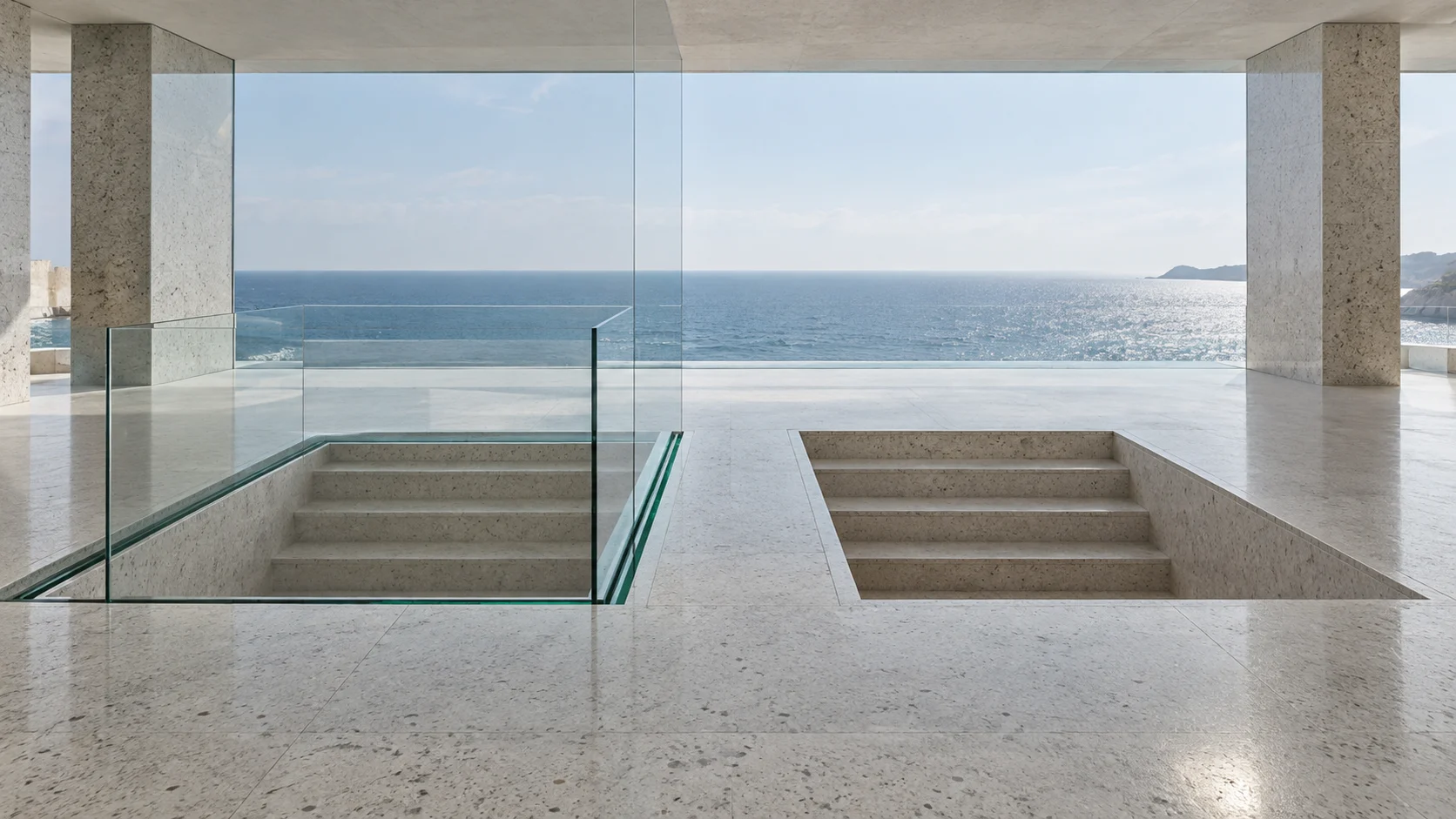 Two identical sunken flights of steps in a terrazzo floor above the sea: one stands inside a glass balustrade with an emerald edge, the other is left outside it.