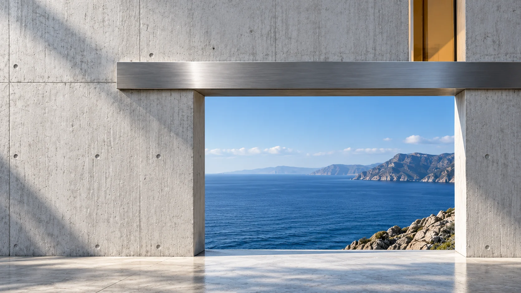 The same concrete wall further along: the steel beam and the lower opening onto the sea are there; above the beam the concrete is closed but for one small opening of amber glass at the upper right.